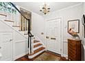 Bright foyer featuring hardwood floors, a staircase, and decorative accents at 39 N Adgers Wharf, Charleston, SC 29401