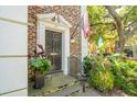 Elegant front entrance with a black door, brick facade, and manicured landscaping at 39 N Adgers Wharf, Charleston, SC 29401