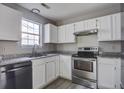 Bright kitchen with stainless steel appliances, white cabinets, and durable countertops at 414 Courtland Dr, Summerville, SC 29486