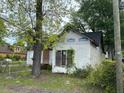 Exterior view of a house in disrepair, with boarded-up windows at 4232 Grimke St, North Charleston, SC 29405
