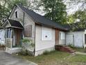 Exterior view of a home boarded up with 'No Trespassing' signs on the front at 4232 Grimke St, North Charleston, SC 29405