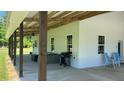 Wide exterior shot with spacious patio with ceiling fan, and barbecue at 4911 Chisolm Rd, Johns Island, SC 29455