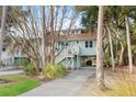 Home exterior featuring a covered area underneath and a long driveway at 507 Cobby Creek Ln, Seabrook Island, SC 29455