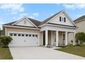 Beautiful home with a two car garage, covered porch, and manicured lawn at 589 Crossland Dr, Moncks Corner, SC 29461