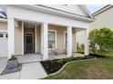 Inviting front porch with seating and decorative flower beds at 589 Crossland Dr, Moncks Corner, SC 29461