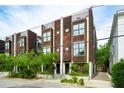 Street view of modern townhomes boasting wood facades and lush landscaping, enhancing curb appeal at 62 Gadsden St # A, Charleston, SC 29401