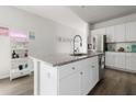Stylish kitchen with white cabinets, stainless steel appliances, granite countertops, and a modern island at 655 Jancus St, Charleston, SC 29414