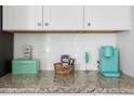 Close-up shot of the kitchen countertop featuring white subway tile, a mint Keurig, and tasteful decor at 655 Jancus St, Charleston, SC 29414