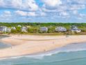 Stunning aerial view of the beach and beautiful homes nestled along the coastline at 67 Lost Village Trl # 8, Edisto Island, SC 29438