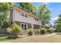 Charming two-story home with a brick facade, lush landscaping, and a welcoming front entrance at 679 Edmonds Dr, Charleston, SC 29412