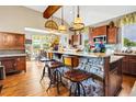 Open-concept kitchen with stone island, pendant lights, and stainless steel appliances at 7875 Berry Manor Ln, Edisto Island, SC 29438
