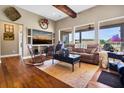 Cozy living room with hardwood floors, large windows, and comfortable seating at 7875 Berry Manor Ln, Edisto Island, SC 29438