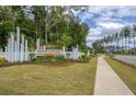 Community entrance showcasing decorative landscaping and a welcoming sign at 1034 Marsh Harrier Dr # Cc3-4-3, Ravenel, SC 29470