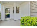 Close up of the covered front porch with white siding and trim at 118 Billowing Sails St, Summerville, SC 29486