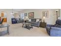 Spacious living room with neutral tones, plush seating, and abundant natural light at 118 Billowing Sails St, Summerville, SC 29486