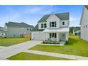 Attractive two-story home with a green roof, a two-car garage, and landscaped front yard at 1226 Spotflower St, Summerville, SC 29485