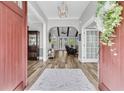 Inviting foyer with hardwood floors, decorative lighting, and an open view of the living spaces at 1245 Saddlehorn Rd, Summerville, SC 29486