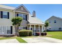Inviting townhome with manicured lawn, mature landscaping, and a cozy front entrance at 132 Lynches River Dr, Summerville, SC 29485