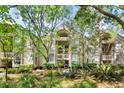 Well maintained building exterior surrounded by mature landscaping and trees at 1332 Pelican Watch Villas, Seabrook Island, SC 29455