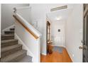 Charming foyer features gleaming hardwood floors, coat rack, and a staircase leading to the upper level at 1349 Hamlin Park Cir, Mount Pleasant, SC 29466