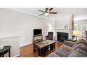 Cozy living room with a fireplace, hardwood floors, and comfortable furnishings, perfect for relaxation at 1349 Hamlin Park Cir, Mount Pleasant, SC 29466