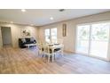 Bright dining area featuring modern lighting, wood floors, and sliding glass doors to outside at 1358 Givhans Rd, Ridgeville, SC 29472