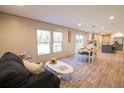 Inviting living room featuring wood floors, ample natural light, and seamless flow to dining and kitchen at 1358 Givhans Rd, Ridgeville, SC 29472