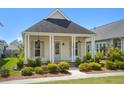 Charming single-story home featuring a covered porch with classic columns and manicured landscaping at 139 Clear Bend Ln, Summerville, SC 29486