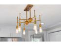 A statement brass chandelier illuminates this kitchen space with style at 14 Paula Dr, Charleston, SC 29407