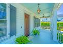 Welcoming front porch with stylish lighting, decorative plants, and a cozy atmosphere with painted ceilings at 1510 Windlass Way, Mount Pleasant, SC 29466