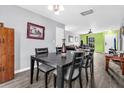 Open concept dining room showcases a dark wood table, with seating for six, seamlessly connected to other living spaces at 1516 Mandarin Ct, Summerville, SC 29483