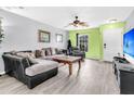 Well-lit living room showcases a comfortable sofa, a wooden coffee table, and a modern entertainment center at 1516 Mandarin Ct, Summerville, SC 29483