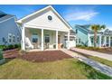 Inviting single-story home with a covered porch and colorful front door at 1521 Pogonia St # 4, Mount Pleasant, SC 29466