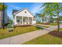 Beautiful single-Gathering home featuring a cozy front porch and lush greenery at 1521 Pogonia St # 4, Mount Pleasant, SC 29466