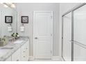 Clean bathroom featuring a glass-enclosed shower, granite countertops, and framed mirror at 154 Royal Cainhoy Way, Huger, SC 29450