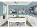 Bright home office with white desk, decorative lamps, and tranquil artwork at 154 Royal Cainhoy Way, Huger, SC 29450