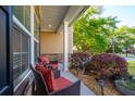 Cozy front porch with comfortable seating area, manicured landscaping, and beautiful natural light at 1606 Stovall Ct, Johns Island, SC 29455
