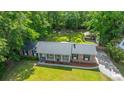 Aerial view of brick home with well-maintained lawn, mature trees, and detached structure in the expansive backyard at 1621 Wannamaker Ave, Summerville, SC 29485