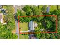 Aerial view of home and property lines surrounded by mature trees and neighboring houses in a residential area at 1621 Wannamaker Ave, Summerville, SC 29485