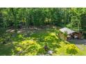 Lush backyard with detached structure amidst mature trees and greenery, enhancing privacy and outdoor enjoyment at 1621 Wannamaker Ave, Summerville, SC 29485