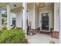 Inviting front porch with decorative accents, comfortable seating, and charming curb appeal at 1901 Toland Ct, Johns Island, SC 29455