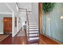 Bright foyer featuring hardwood floors, a staircase, and a view of the living space at 2009 Terrabrook Ln, Charleston, SC 29412