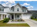 Charming two-story home with a metal roof, a covered porch and a well-manicured front yard at 206 Evergreen Ave, Summerville, SC 29485