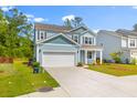 Beautiful blue two-story home with a two car garage and a well manicured lawn at 208 Cherry Grove Dr, Summerville, SC 29483