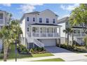 Beautiful two-story home boasts a welcoming front porch, elevated design, and picturesque landscaping at 2194 Cultura Cir, Mount Pleasant, SC 29466