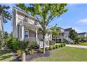 Charming two-story home featuring a welcoming front porch, manicured lawn, and mature landscaping at 2636 Colonel Harrison Dr, Johns Island, SC 29455