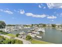 Scenic aerial view of a marina filled with boats and surrounded by waterfront homes against a blue sky at 30 Yacht Harbor Ct, Isle of Palms, SC 29451