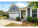 Beautiful home with a two-car garage, well-manicured landscaping, and inviting front entrance with wreath at 3061 Cross Vine Ln, Summerville, SC 29483