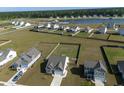 Aerial view of neighborhood with large lots and a lake in the distance at 312 Cypress Branch Rd, Huger, SC 29450