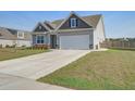 This attractive, single Gathering home features a well-manicured lawn at 312 Cypress Branch Rd, Huger, SC 29450